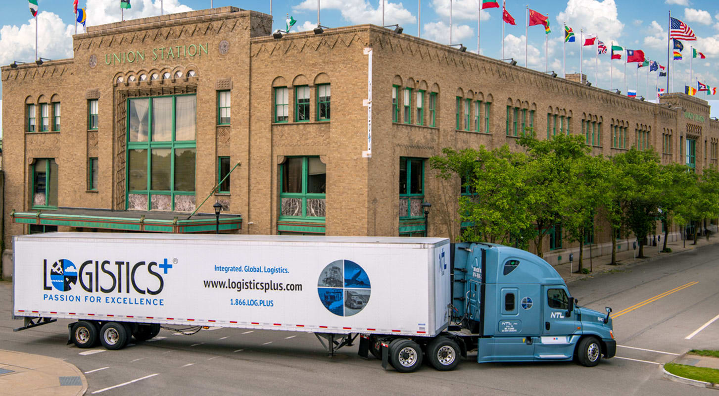 A large Logistics plus trailer is shown in front of Union Station Global Headquarters building.